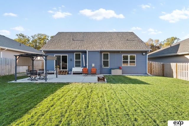 rear view of property featuring a patio area and a yard