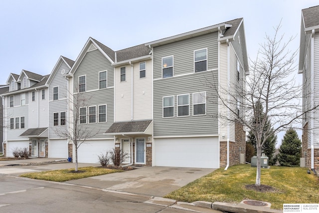 multi unit property with a front lawn and a garage