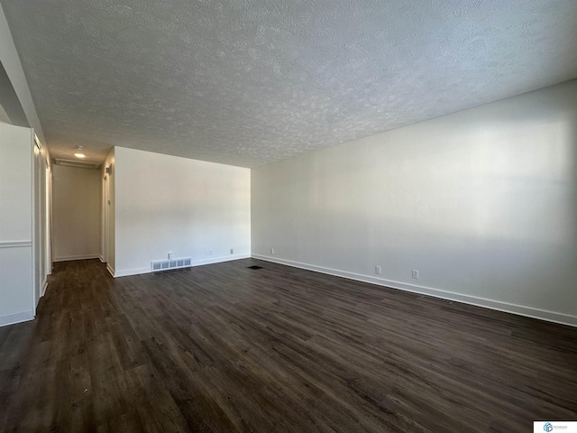 unfurnished room featuring a textured ceiling and dark wood-type flooring