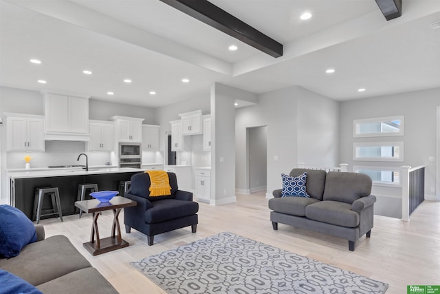 living room with beam ceiling and light hardwood / wood-style floors