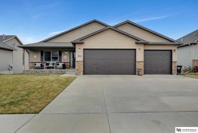 view of front of home with a garage, covered porch, and a front yard