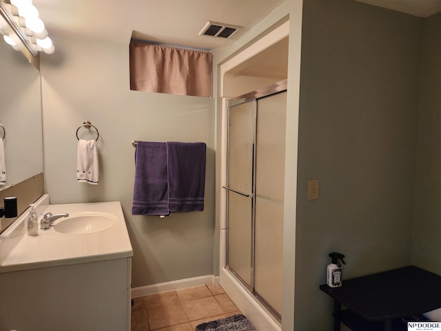 bathroom with tile patterned floors, vanity, and a shower with shower door