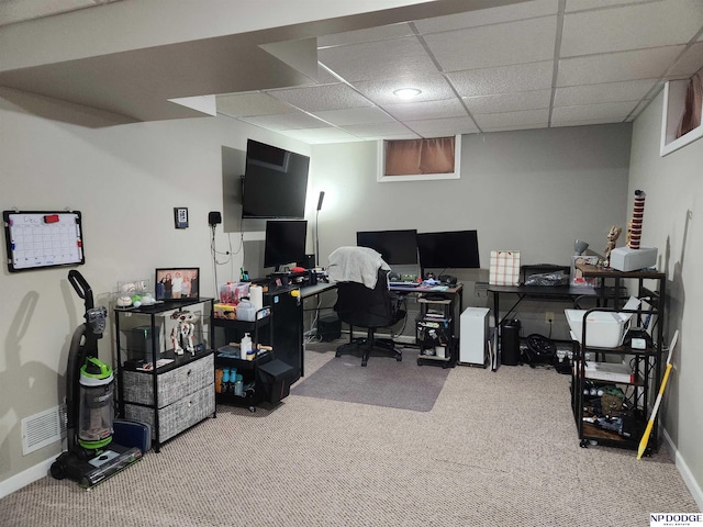 carpeted office with a drop ceiling