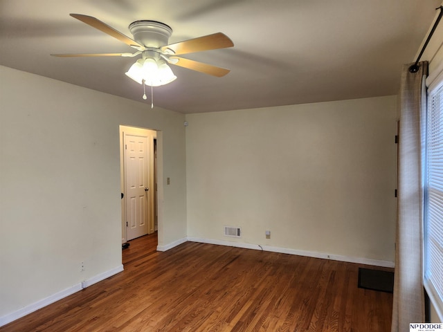 unfurnished room with ceiling fan and dark wood-type flooring