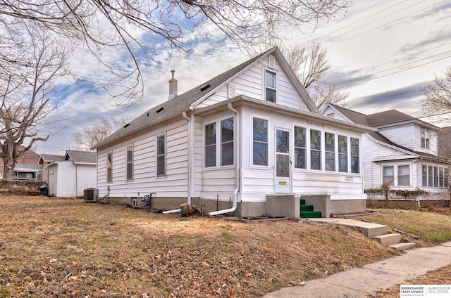 exterior space featuring central AC unit and a sunroom