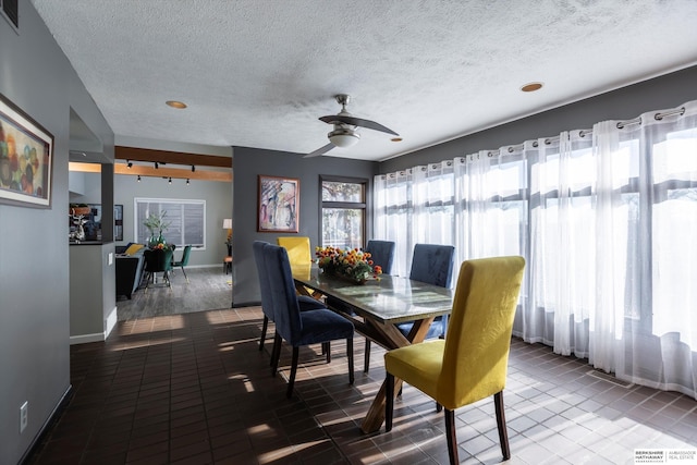 dining area with ceiling fan and a textured ceiling