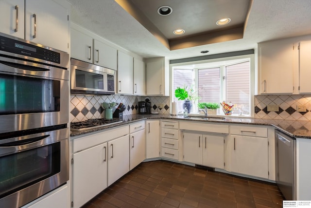 kitchen featuring white cabinetry, sink, and appliances with stainless steel finishes