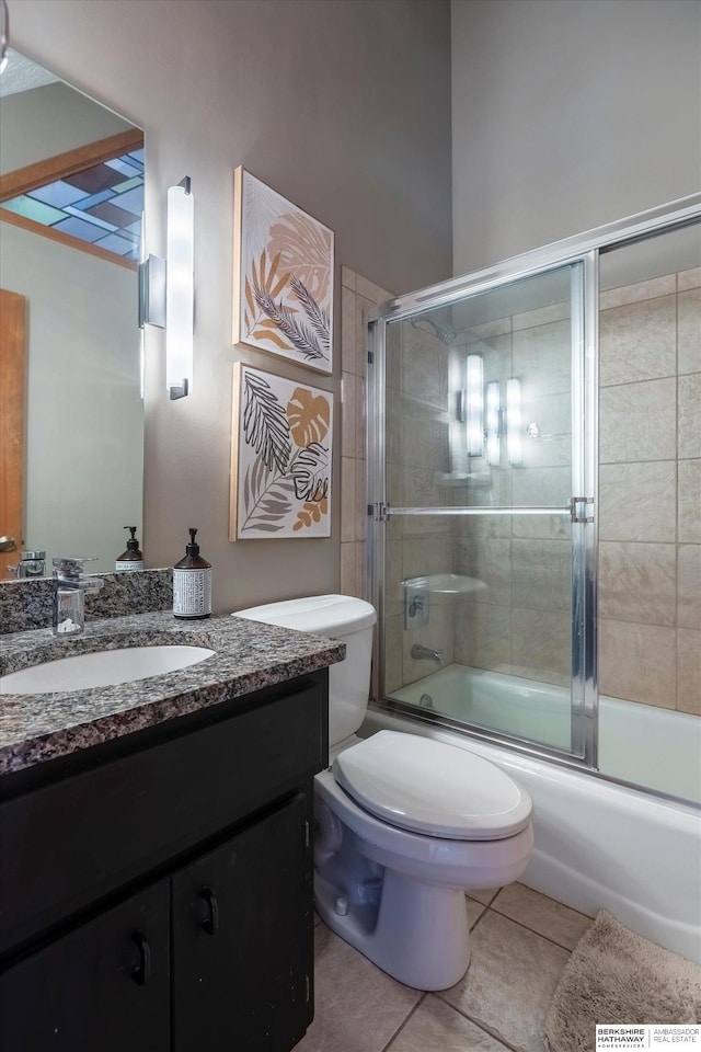 full bathroom featuring tile patterned flooring, vanity, toilet, and enclosed tub / shower combo