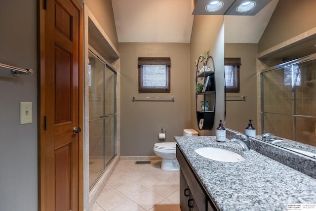 bathroom with vanity, lofted ceiling, tile patterned flooring, toilet, and a shower with shower door