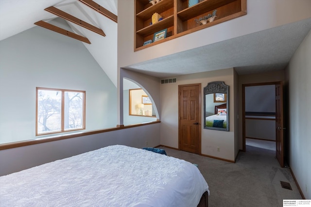 bedroom with beam ceiling, carpet floors, and high vaulted ceiling