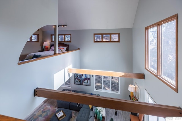 stairs featuring hardwood / wood-style flooring and vaulted ceiling