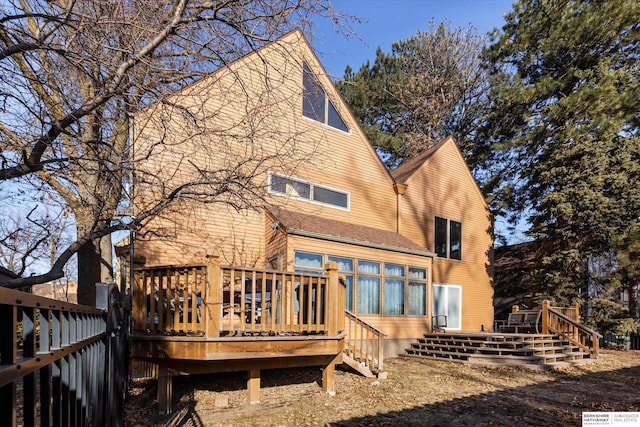 back of house with a wooden deck