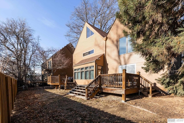 back of property featuring a wooden deck