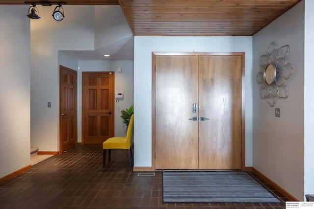 foyer entrance featuring wood ceiling