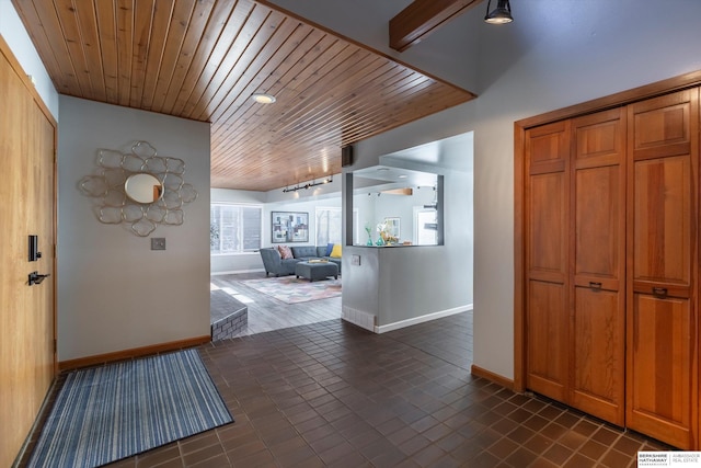 hall with wood ceiling and rail lighting