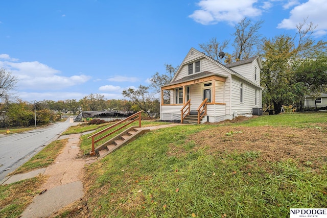 view of front of home featuring a front lawn and central AC unit