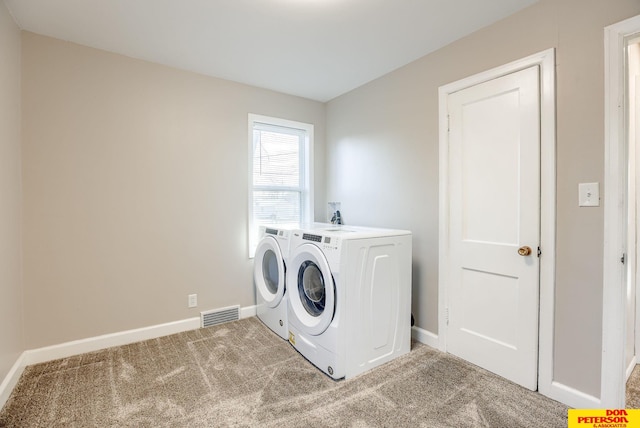 laundry room with washer and clothes dryer and carpet floors