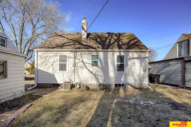 back of property with a lawn and cooling unit