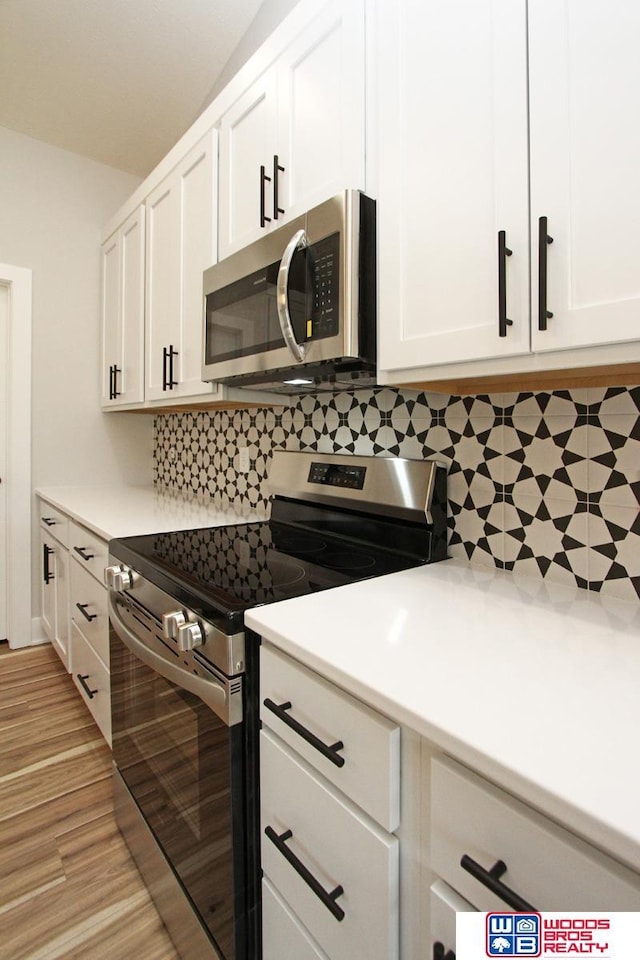 kitchen with white cabinets and appliances with stainless steel finishes