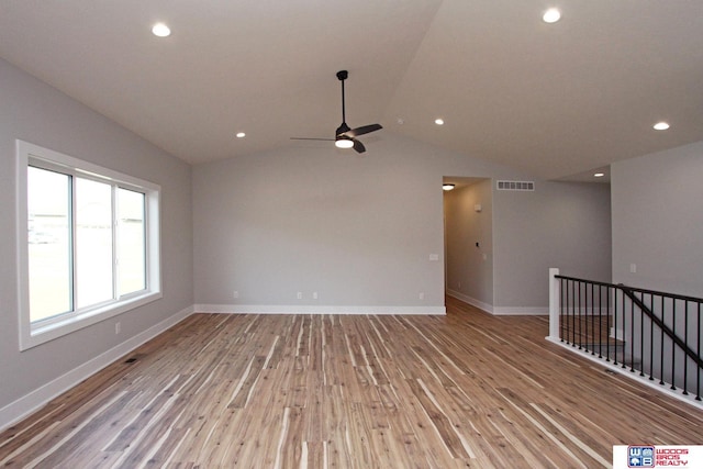 empty room featuring ceiling fan, light hardwood / wood-style floors, and vaulted ceiling