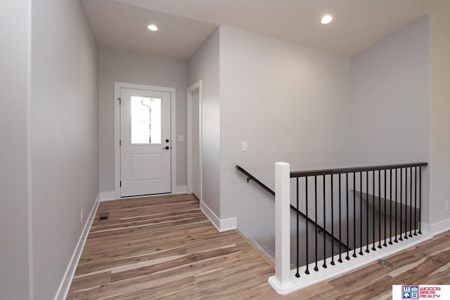 entryway with wood-type flooring