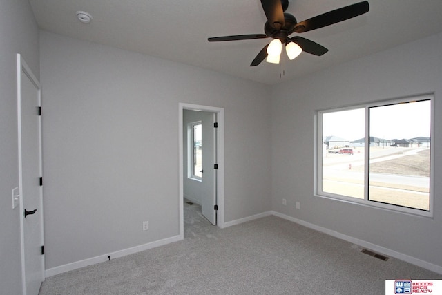 carpeted empty room featuring ceiling fan