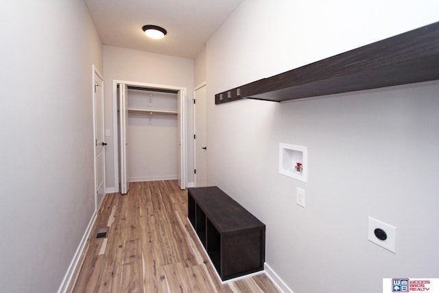 laundry room featuring light wood-type flooring, hookup for a washing machine, and electric dryer hookup