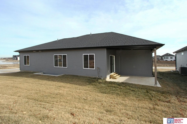 back of house with a lawn, central air condition unit, and a patio area