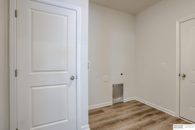 laundry area with light hardwood / wood-style floors and electric dryer hookup