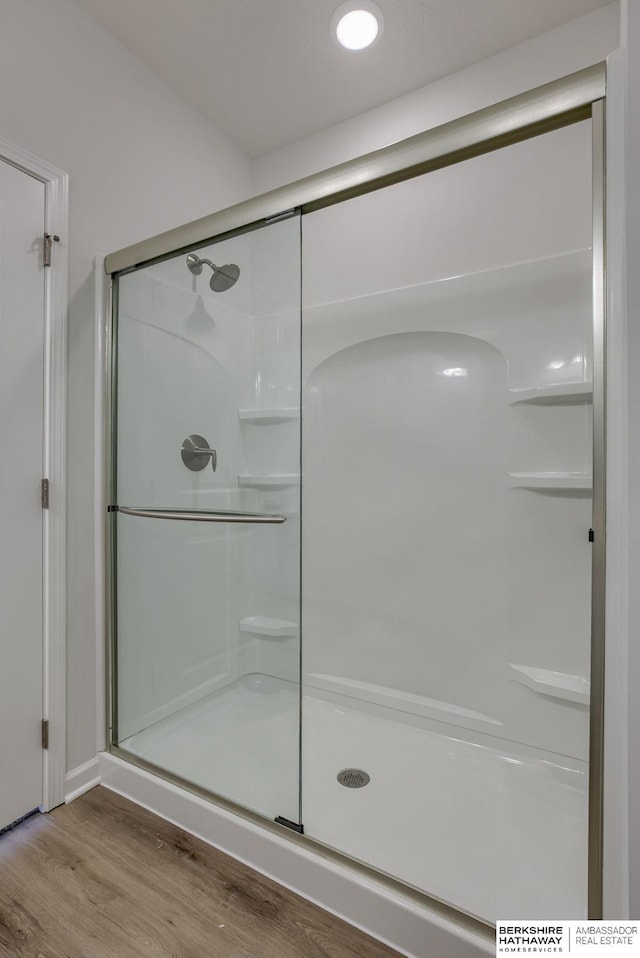 bathroom with walk in shower and hardwood / wood-style flooring