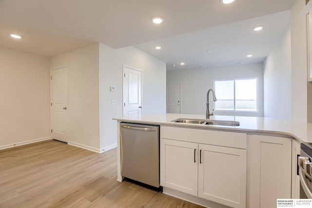 kitchen with stainless steel dishwasher, white cabinets, recessed lighting, and a sink