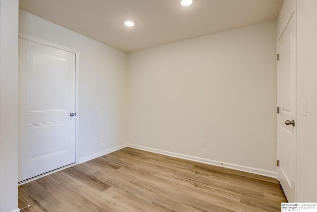 spare room featuring recessed lighting, baseboards, and light wood-style floors