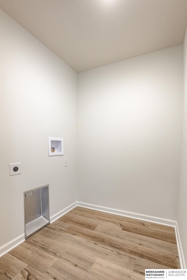 laundry area featuring light wood finished floors, baseboards, laundry area, hookup for a washing machine, and hookup for an electric dryer