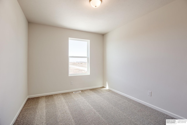 carpeted empty room with baseboards and visible vents