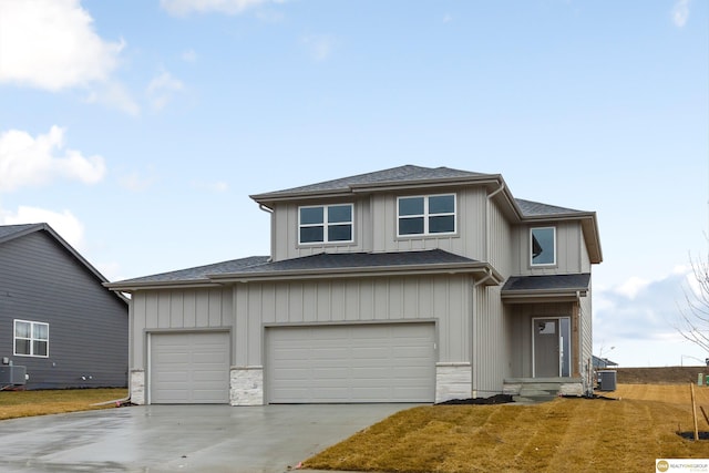 view of front of property featuring cooling unit and a garage