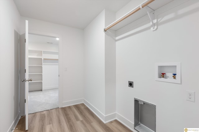 laundry area featuring hookup for an electric dryer, hookup for a washing machine, and light hardwood / wood-style flooring