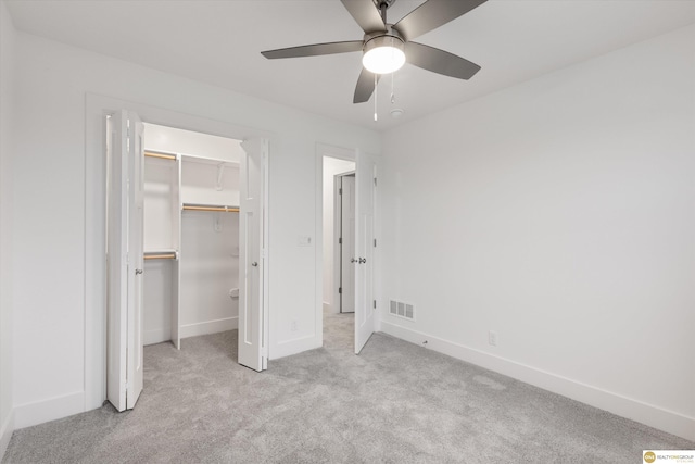 unfurnished bedroom featuring ceiling fan, light carpet, and a closet