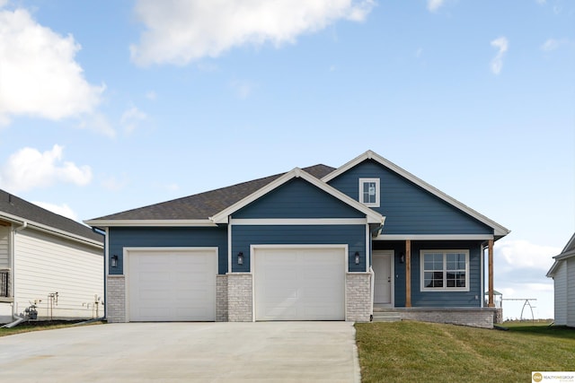 view of front of property with a front yard and a garage