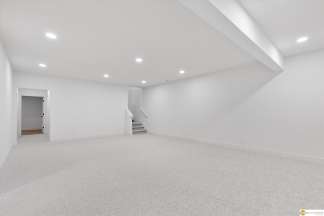 basement featuring light carpet