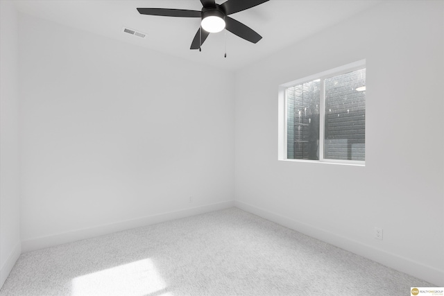 spare room featuring ceiling fan and carpet floors