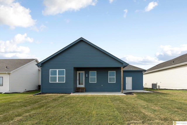 rear view of property with a patio, cooling unit, and a lawn