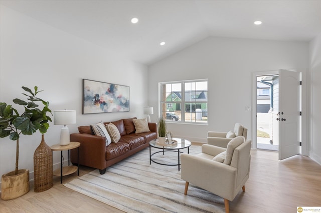 living room featuring light hardwood / wood-style floors and lofted ceiling