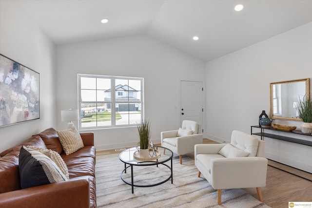 living room with light hardwood / wood-style floors and lofted ceiling