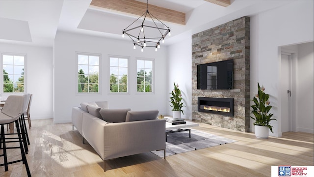 living room featuring beam ceiling, a notable chandelier, a fireplace, and light hardwood / wood-style floors