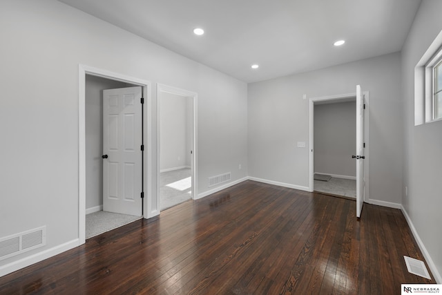 spare room with dark wood-type flooring