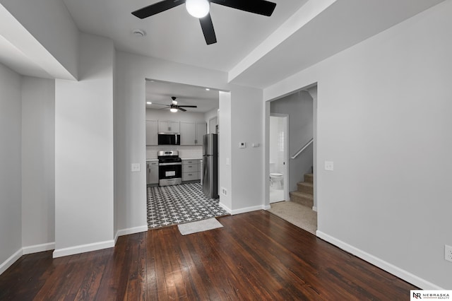 interior space with dark hardwood / wood-style flooring and ceiling fan