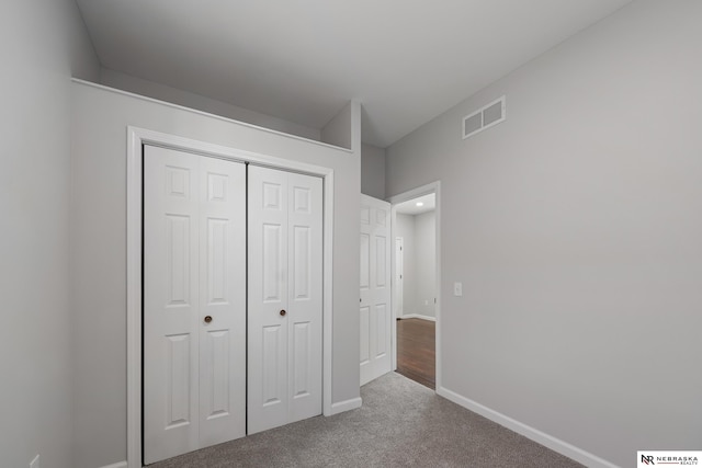 unfurnished bedroom with carpet and a closet