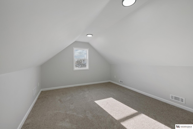 bonus room with carpet and lofted ceiling