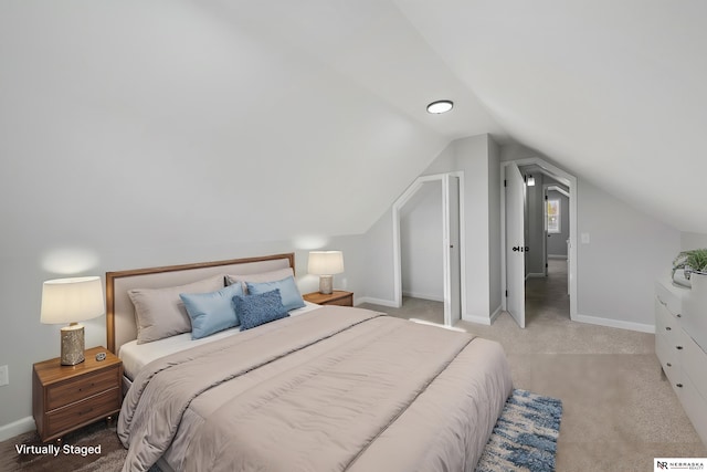 carpeted bedroom featuring vaulted ceiling