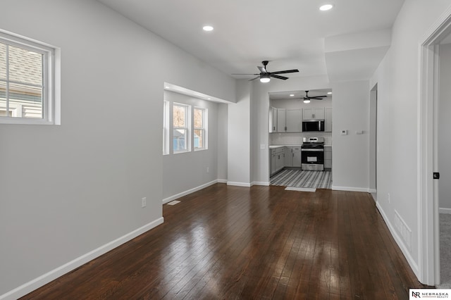 unfurnished living room with ceiling fan and dark hardwood / wood-style flooring